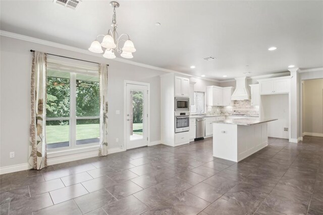 5625 Courtland Ln, Choctaw, OK 73020 - kitchen with appliances with stainless steel finishes, custom exhaust hood, decorative backsplash, ornamental molding, and a chandelier