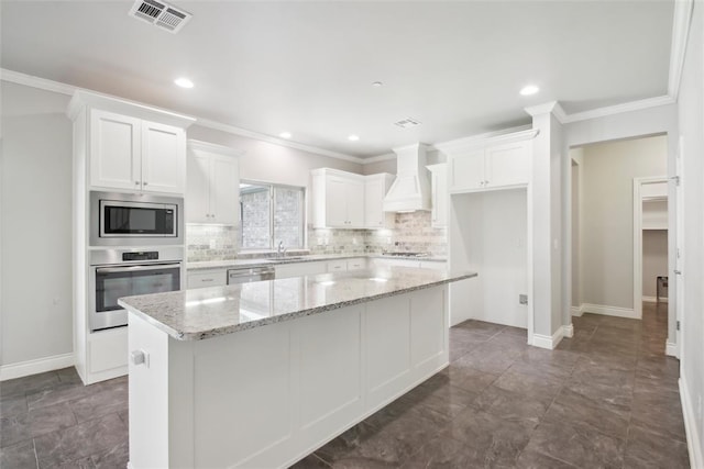5625 Courtland Ln, Choctaw, OK 73020 - kitchen featuring appliances with stainless steel finishes, a sink, custom range hood, white cabinets, and backsplash