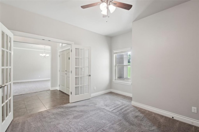 5625 Courtland Ln, Choctaw, OK 73020 - carpeted spare room with french doors, a ceiling fan, a chandelier, tile patterned floors, and baseboards