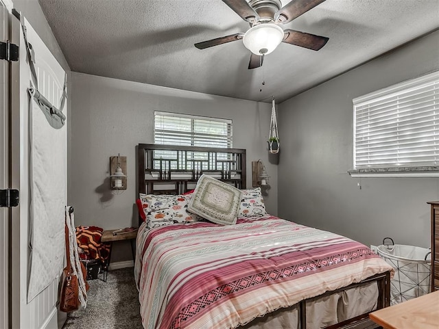 717 SW 4th Pl, Moore, OK 73160 - bedroom featuring carpet flooring, a textured ceiling, and a ceiling fan