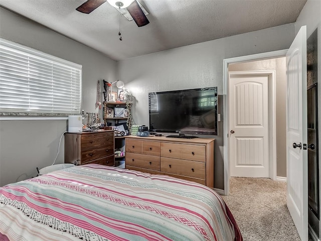 717 SW 4th Pl, Moore, OK 73160 - carpeted bedroom featuring a textured ceiling and a ceiling fan
