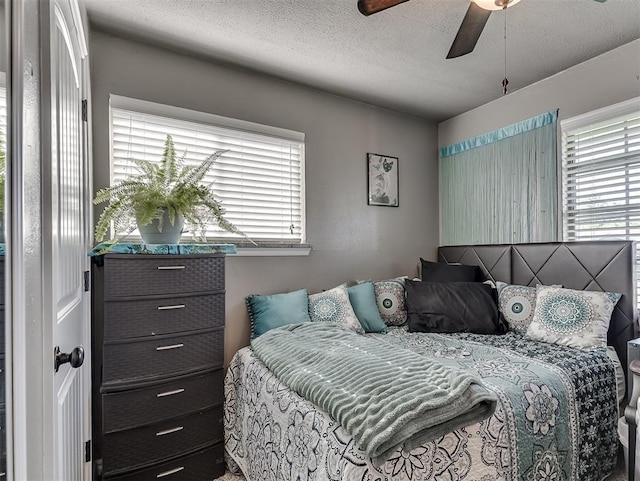 717 SW 4th Pl, Moore, OK 73160 - bedroom with a textured ceiling and ceiling fan