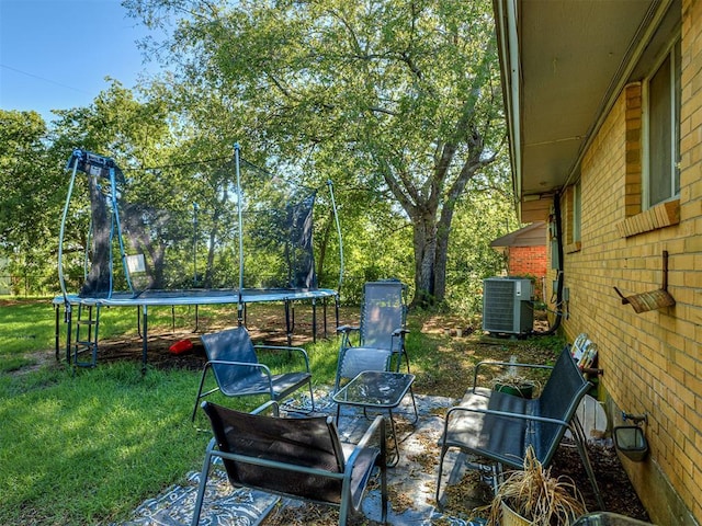 717 SW 4th Pl, Moore, OK 73160 - view of patio / terrace featuring a trampoline and central air condition unit
