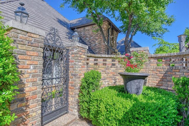 3517 Brookford Dr, Norman, OK 73072 - view of home's exterior featuring brick siding, a gate, and fence