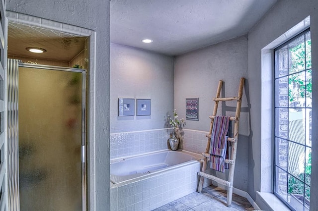 3517 Brookford Dr, Norman, OK 73072 - full bathroom featuring a shower stall, a textured wall, a garden tub, tile patterned floors, and baseboards