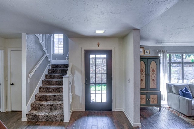 3517 Brookford Dr, Norman, OK 73072 - foyer entrance featuring wood-type flooring, healthy amount of natural light, a textured ceiling, stairway, and baseboards