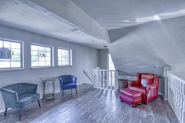 3517 Brookford Dr, Norman, OK 73072 - living area with an upstairs landing, wood finished floors, a textured ceiling, healthy amount of natural light, and a textured wall