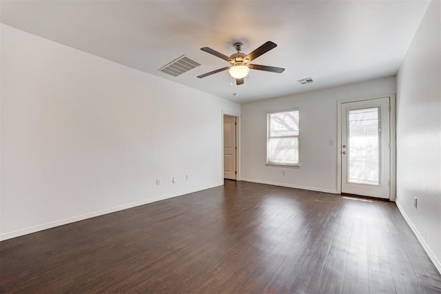 unfurnished room featuring a ceiling fan, dark wood-style flooring, and baseboards