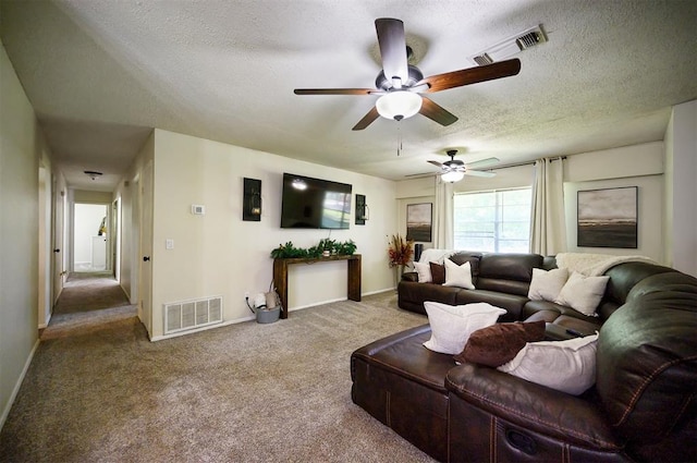 308 E Highland St, Hugo, OK 74743 - living area with a ceiling fan, carpet floors, a textured ceiling, and baseboards