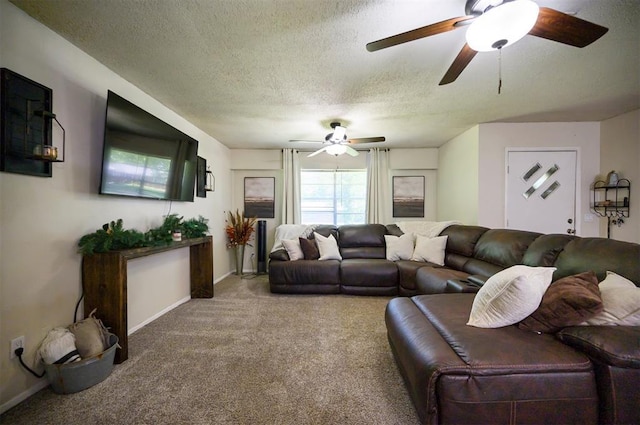 308 E Highland St, Hugo, OK 74743 - carpeted living room featuring a ceiling fan, a textured ceiling, and baseboards