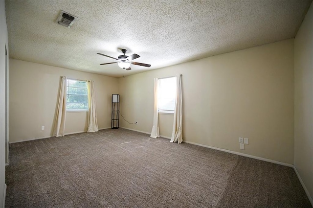 308 E Highland St, Hugo, OK 74743 - unfurnished room featuring ceiling fan, carpet, a textured ceiling, and baseboards