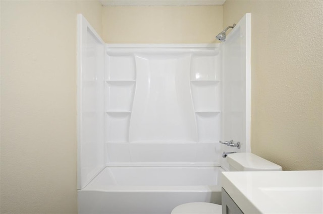 308 E Highland St, Hugo, OK 74743 - bathroom featuring vanity, shower / washtub combination, toilet, and a textured wall