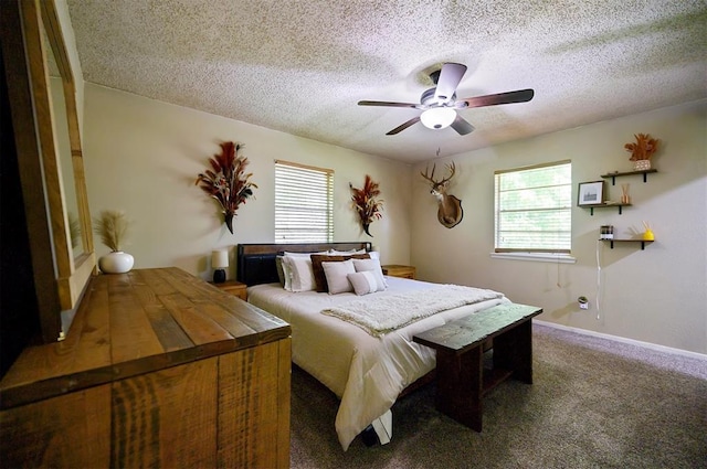 308 E Highland St, Hugo, OK 74743 - bedroom featuring multiple windows, a textured ceiling, carpet, ceiling fan, and baseboards