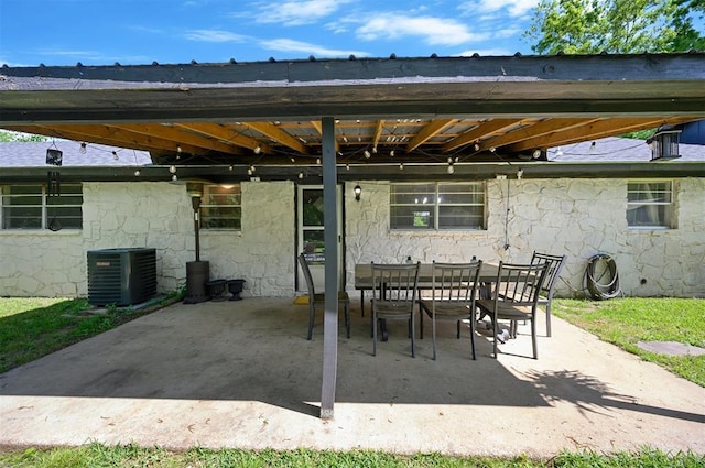 308 E Highland St, Hugo, OK 74743 - view of patio / terrace with central air condition unit and outdoor dining area