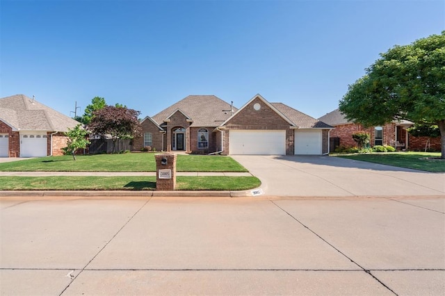 3005 Summit Hill Rd, Norman, OK 73071 - view of front of property featuring a garage, brick siding, a front lawn, and concrete driveway