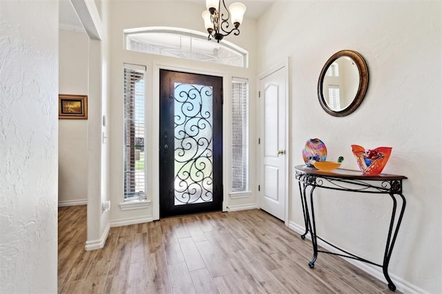 3005 Summit Hill Rd, Norman, OK 73071 - entryway with wood finished floors, a chandelier, and baseboards