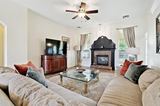 3005 Summit Hill Rd, Norman, OK 73071 - living area with a ceiling fan, a brick fireplace, arched walkways, wood finished floors, and baseboards