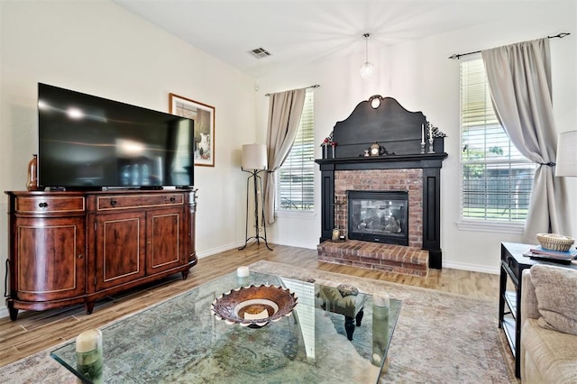 3005 Summit Hill Rd, Norman, OK 73071 - living room with wood finished floors, a fireplace, and baseboards