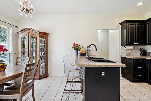3005 Summit Hill Rd, Norman, OK 73071 - kitchen featuring a sink, light tile patterned floors, light countertops, dark cabinetry, and recessed lighting