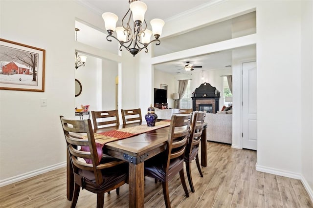 3005 Summit Hill Rd, Norman, OK 73071 - dining room featuring a chandelier, light wood-type flooring, a brick fireplace, ceiling fan, and baseboards