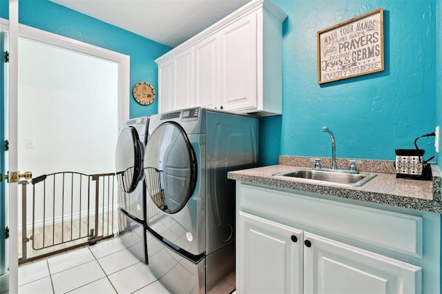 3005 Summit Hill Rd, Norman, OK 73071 - laundry area featuring separate washer and dryer, cabinet space, light tile patterned flooring, and a textured wall