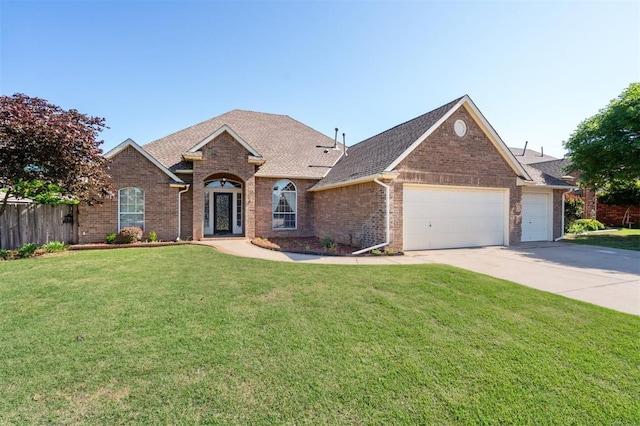 3005 Summit Hill Rd, Norman, OK 73071 - view of front of home with an attached garage, driveway, brick siding, and roof with shingles