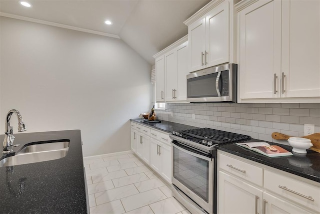 6812 NW 149th St, Oklahoma City, OK 73142 - kitchen with appliances with stainless steel finishes, backsplash, vaulted ceiling, white cabinetry, and dark stone counters