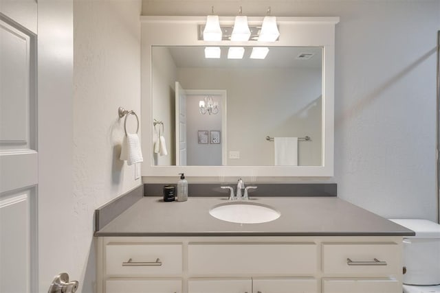 6812 NW 149th St, Oklahoma City, OK 73142 - bathroom featuring vanity, a textured wall, and a chandelier