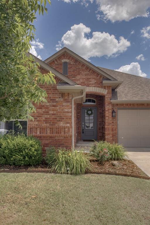 6812 NW 149th St, Oklahoma City, OK 73142 - view of front of property featuring brick siding, an attached garage, concrete driveway, and roof with shingles
