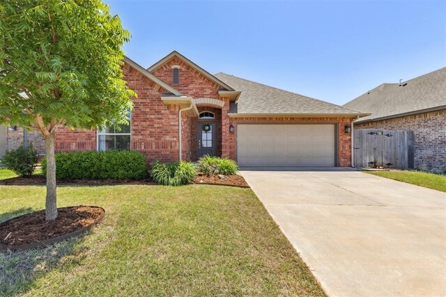 6812 NW 149th St, Oklahoma City, OK 73142 - view of front of home featuring brick siding, a garage, driveway, and roof with shingles