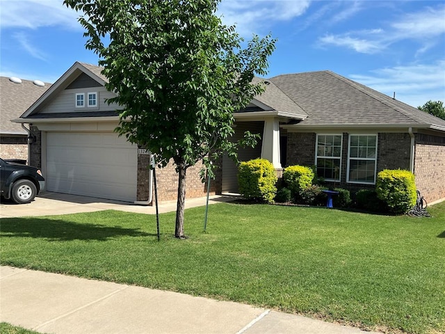 view of front of property featuring a front lawn, brick siding, roof with shingles, driveway, and a garage