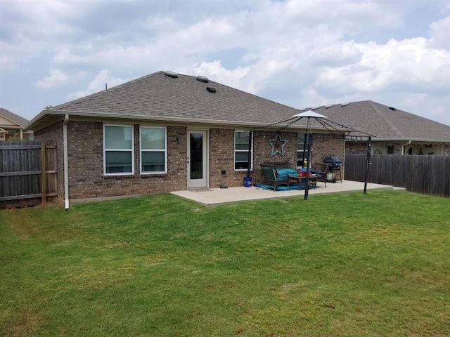 rear view of property featuring a patio area, a shingled roof, brick siding, and an outdoor living space