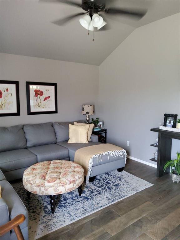 living area with vaulted ceiling, a ceiling fan, baseboards, and wood finished floors