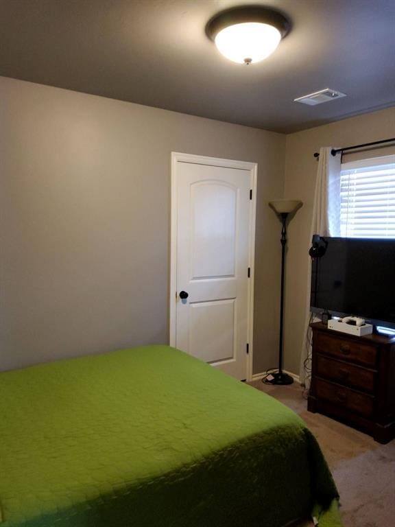 bedroom with light carpet