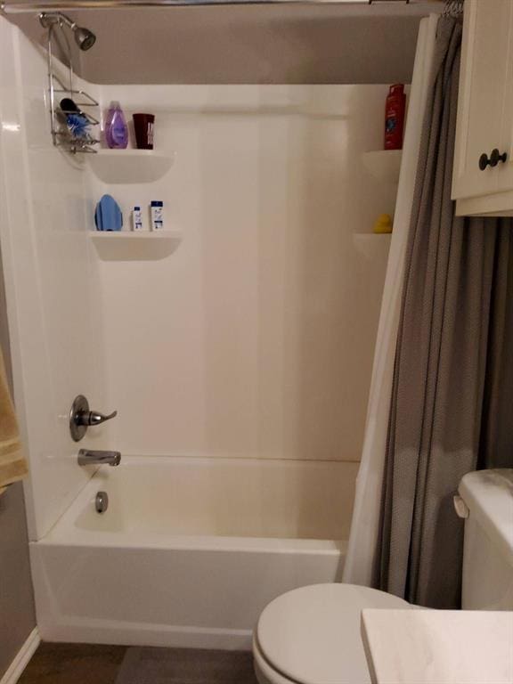 full bath with toilet, shower / tub combo with curtain, and wood finished floors