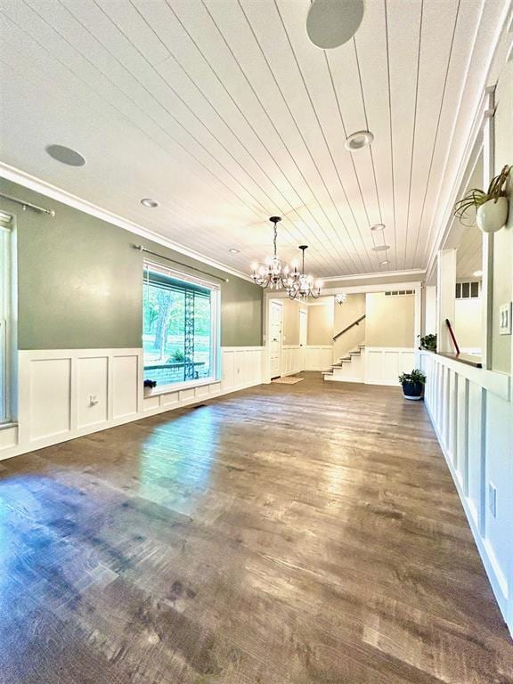 4008 Creekwood, Edmond, OK 73025 - unfurnished dining area with crown molding, a decorative wall, a chandelier, wood finished floors, and stairs