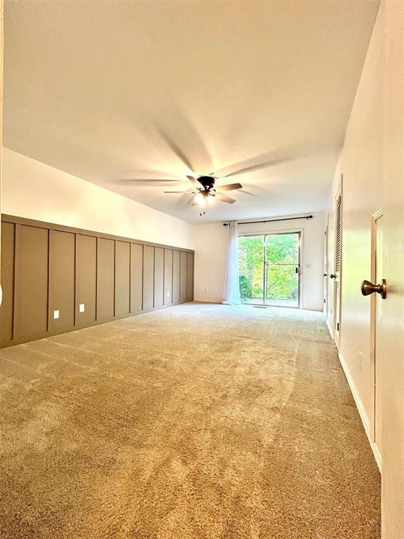 4008 Creekwood, Edmond, OK 73025 - unfurnished room featuring a ceiling fan and carpet flooring