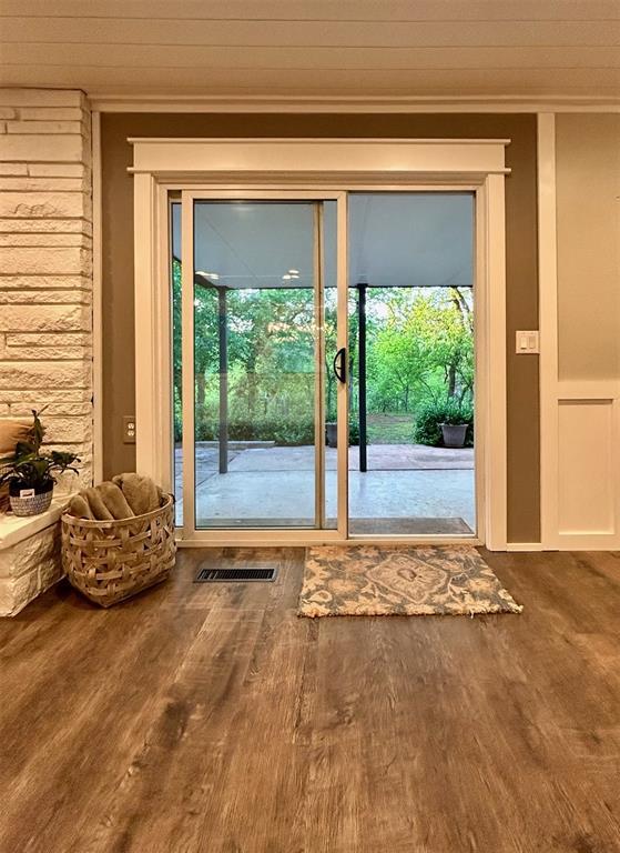 4008 Creekwood, Edmond, OK 73025 - doorway to outside with crown molding, wood finished floors, and healthy amount of natural light