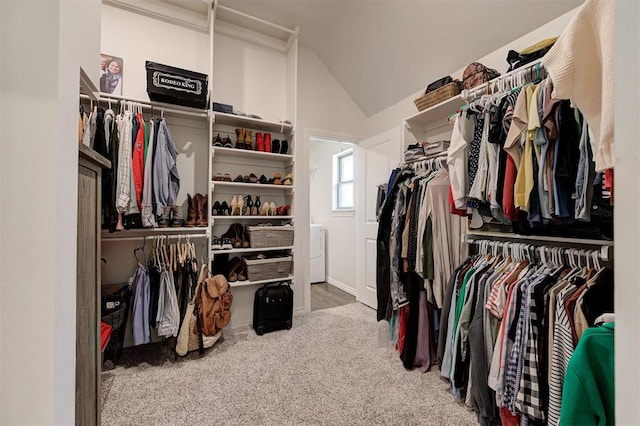 spacious closet featuring lofted ceiling and carpet floors