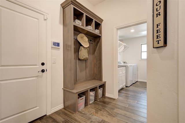 mudroom with washing machine and clothes dryer, baseboards, and wood finished floors