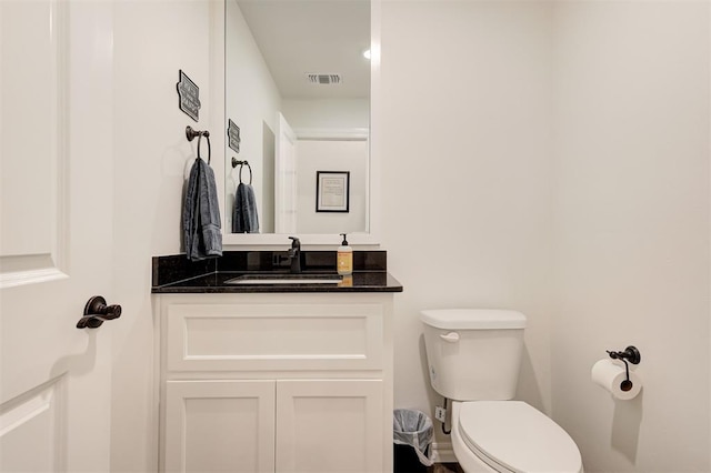 bathroom with toilet and vanity