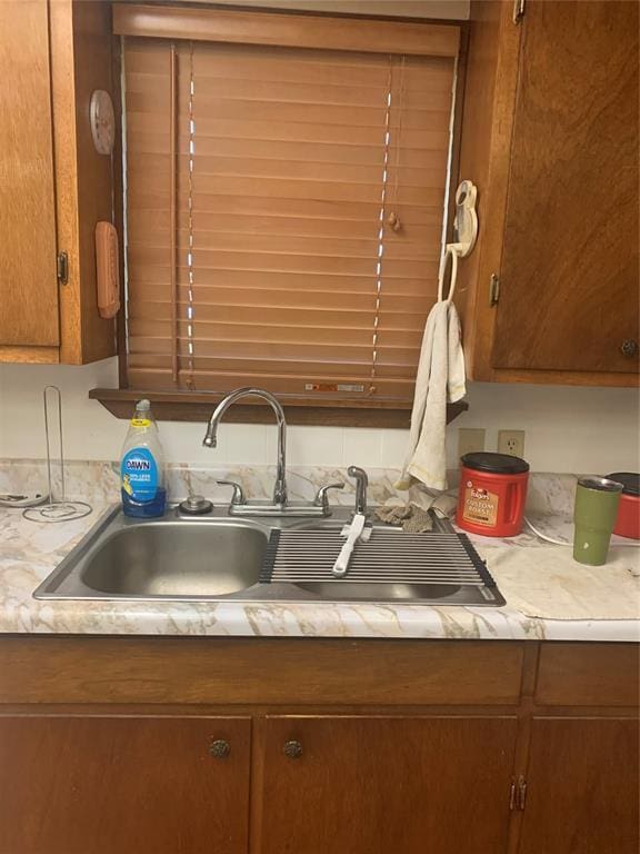 845 N Washington Ave, Mountain View, OK 73062 - kitchen view of light countertops, a sink, and brown cabinets