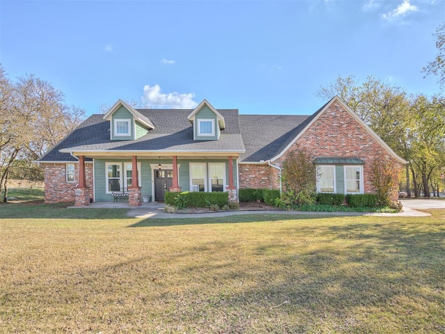24051 Hester Cir, Washington, OK 73093 - view of front facade with a front yard, a porch, and brick siding