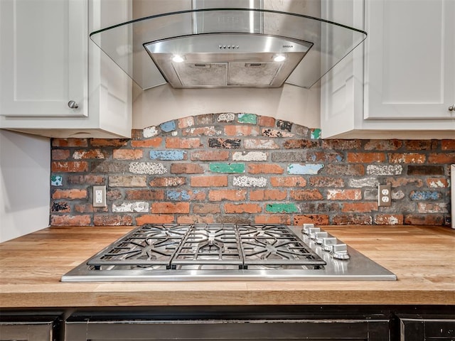 24051 Hester Cir, Washington, OK 73093 - kitchen featuring stainless steel gas cooktop, range hood, white cabinetry, and wood counters