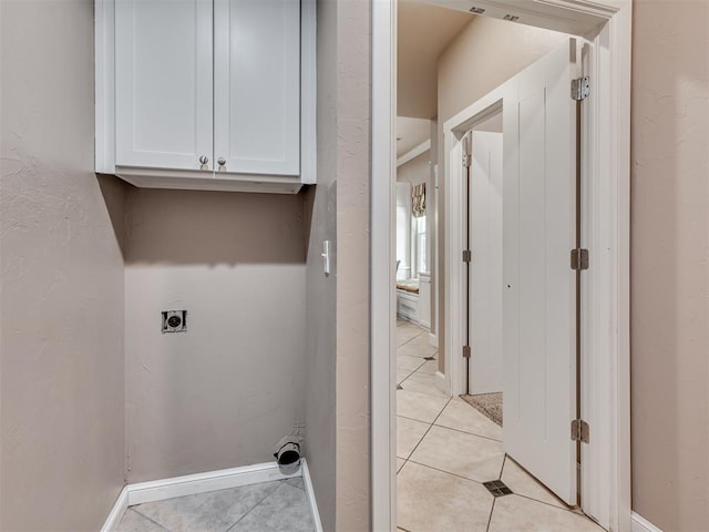 24051 Hester Cir, Washington, OK 73093 - washroom featuring cabinet space, electric dryer hookup, light tile patterned flooring, and baseboards