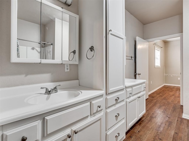 24051 Hester Cir, Washington, OK 73093 - bathroom with double vanity, wood finished floors, and baseboards