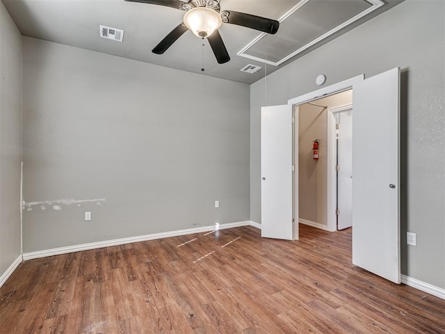 24051 Hester Cir, Washington, OK 73093 - unfurnished bedroom with attic access, wood finished floors, baseboards, and a ceiling fan