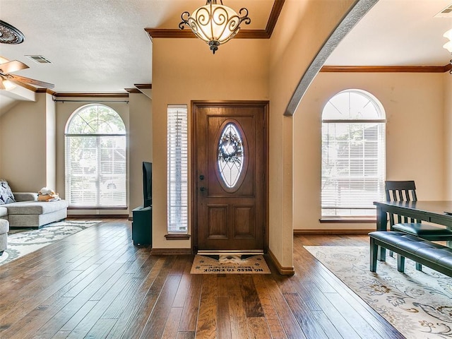 4105 Nailon Dr, Norman, OK 73072 - foyer entrance featuring a chandelier, dark wood-style floors, crown molding, baseboards, and ceiling fan
