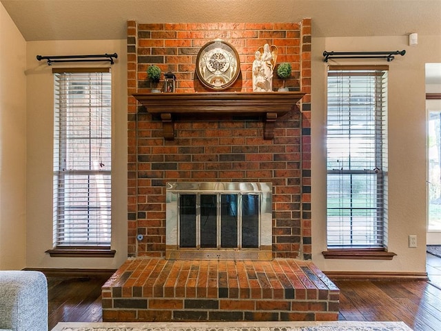 4105 Nailon Dr, Norman, OK 73072 - detailed view of wood finished floors, a brick fireplace, and baseboards