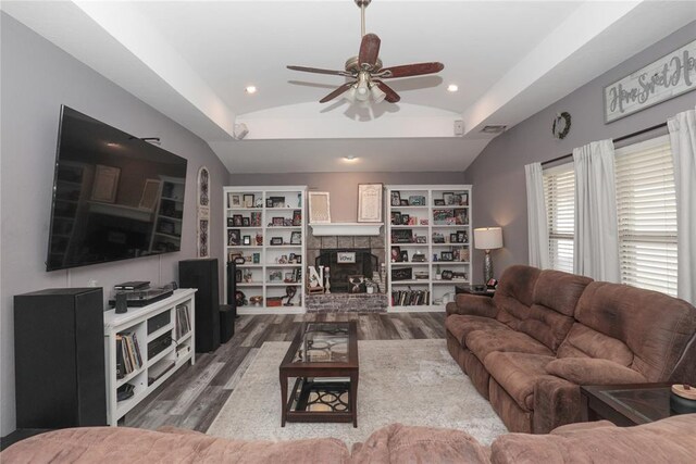 717 Vickery Ave, Yukon, OK 73099 - living room featuring ceiling fan, vaulted ceiling, wood finished floors, a fireplace with raised hearth, and recessed lighting